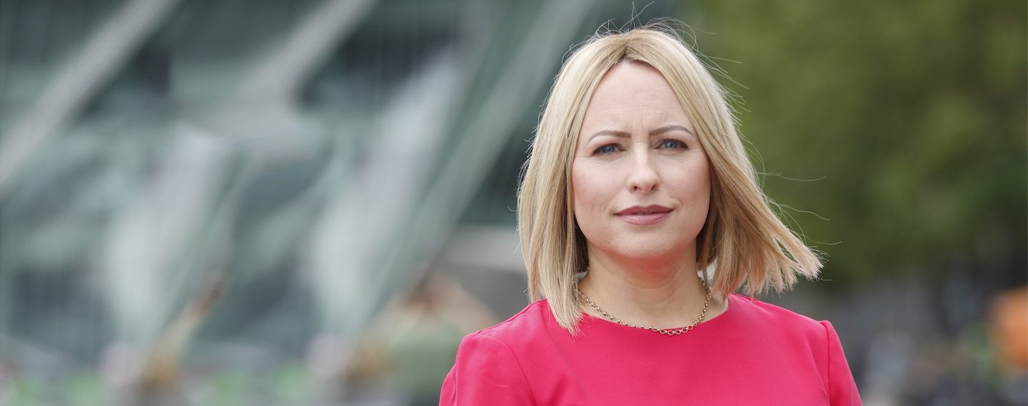 Aoife Lavan is standing outside the institute offices.